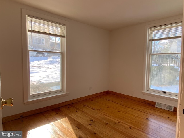 spare room featuring light hardwood / wood-style floors