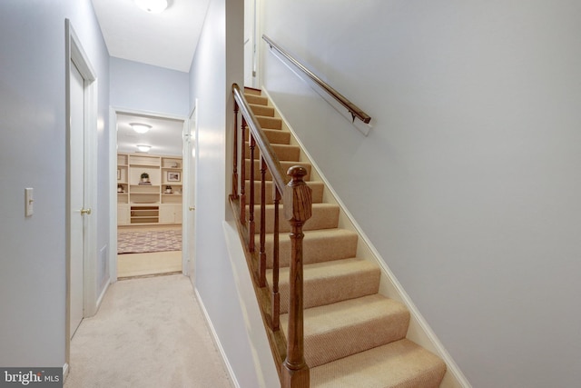 staircase with carpet flooring and baseboards