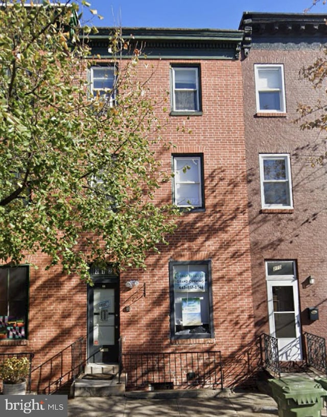 view of front of property with entry steps and brick siding