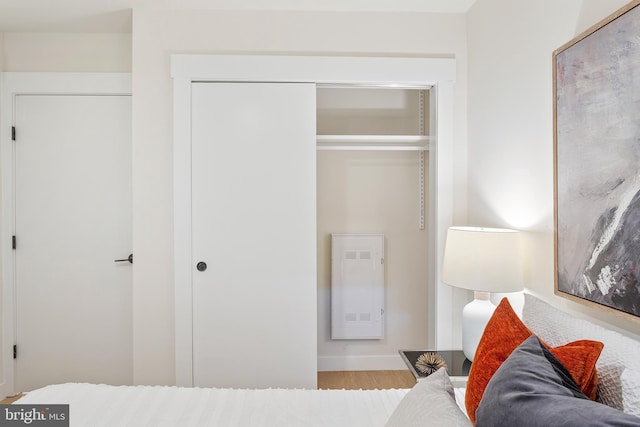 bedroom with a closet and light hardwood / wood-style floors