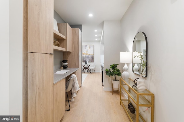 hallway with light hardwood / wood-style flooring