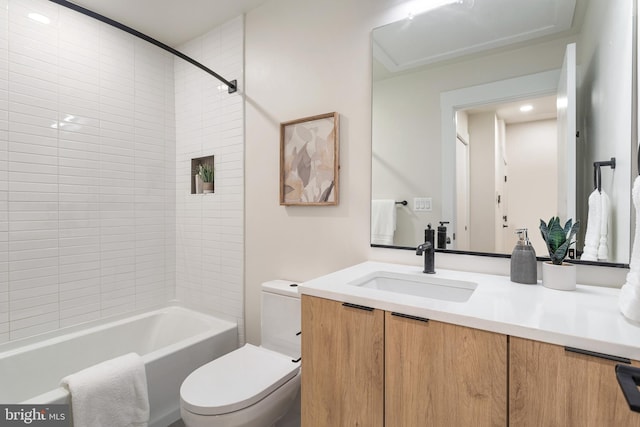 full bathroom with tiled shower / bath combo, vanity, and toilet