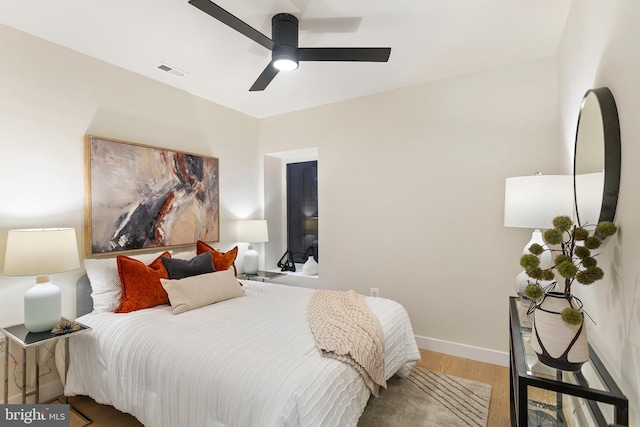 bedroom with hardwood / wood-style flooring and ceiling fan