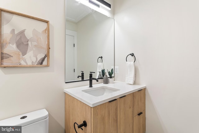 bathroom with toilet and vanity