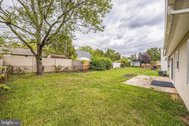 view of yard featuring central AC and a patio area