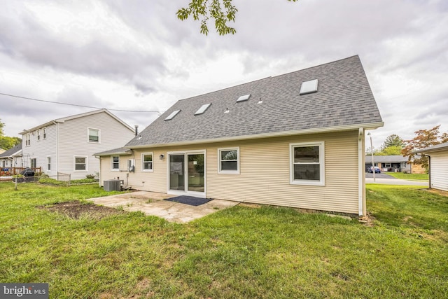 rear view of property with central AC, a patio area, and a yard