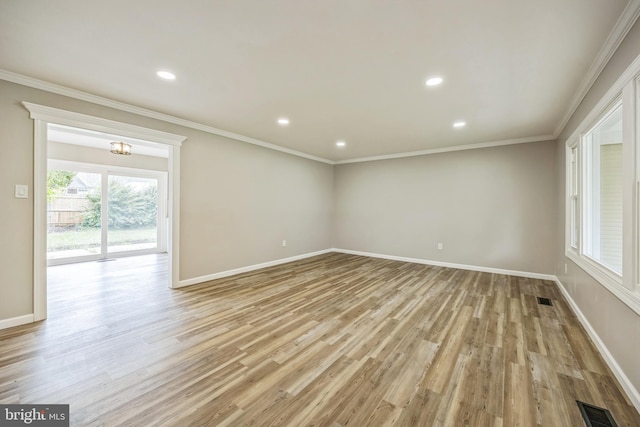 empty room with an inviting chandelier, light wood-type flooring, and ornamental molding