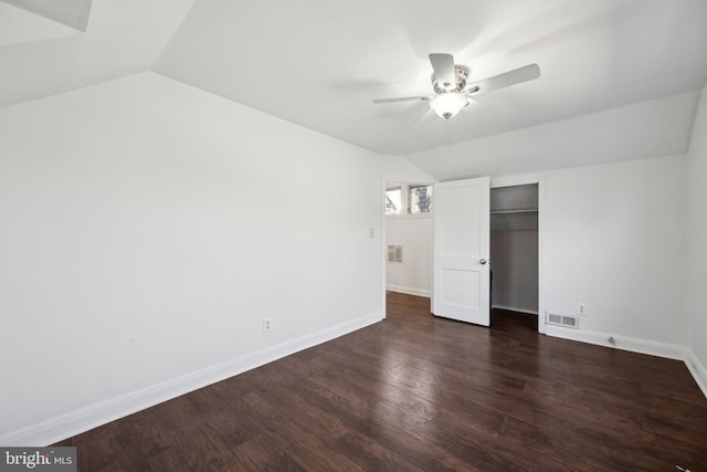 unfurnished bedroom featuring dark wood-type flooring, vaulted ceiling, a closet, and ceiling fan