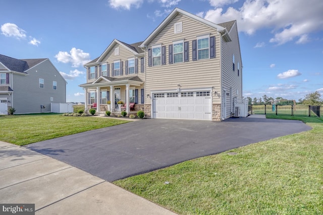 view of front of property with a garage, covered porch, and a front lawn