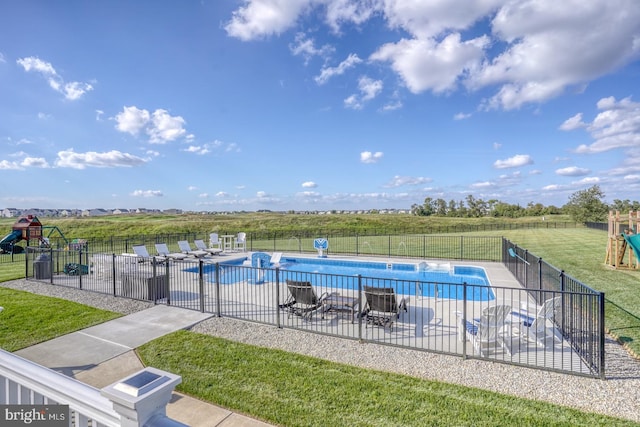 view of swimming pool featuring a yard, a playground, and a patio