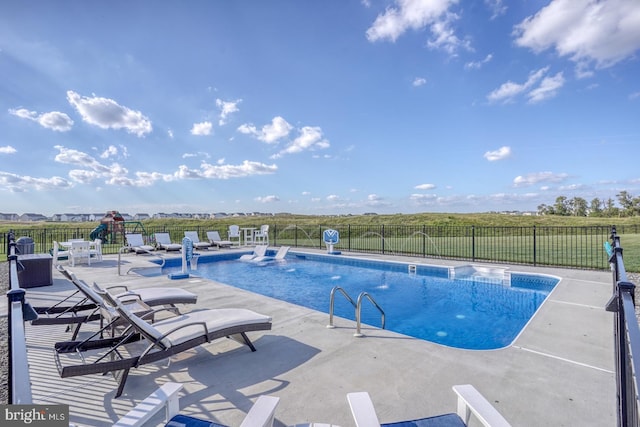 view of pool featuring pool water feature and a patio