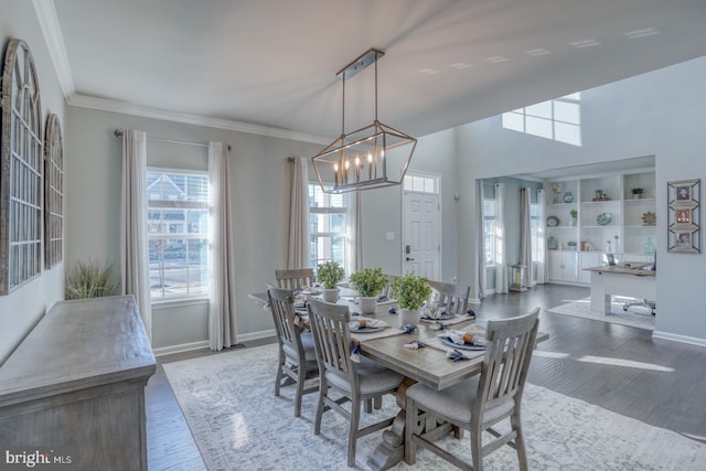 dining room with an inviting chandelier, hardwood / wood-style floors, and ornamental molding