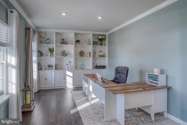 unfurnished office featuring a healthy amount of sunlight, crown molding, and dark wood-type flooring