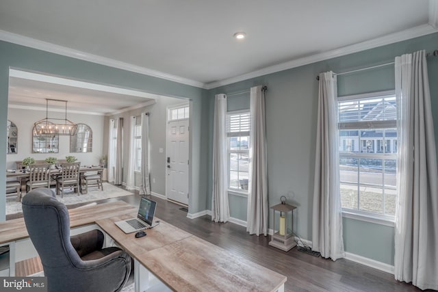 home office featuring crown molding, dark hardwood / wood-style flooring, an inviting chandelier, and a wealth of natural light