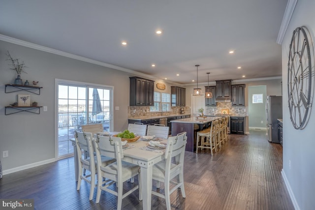 dining area with dark wood-type flooring and ornamental molding