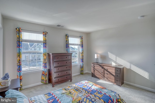 bedroom featuring light colored carpet