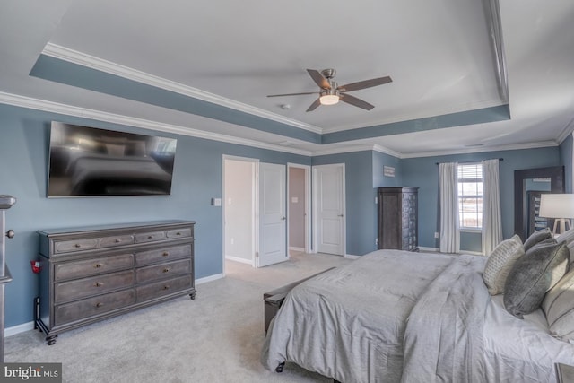 bedroom featuring a raised ceiling, light colored carpet, ceiling fan, and crown molding