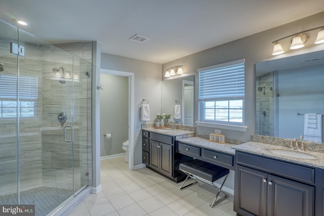 bathroom with toilet, tile patterned floors, walk in shower, and vanity