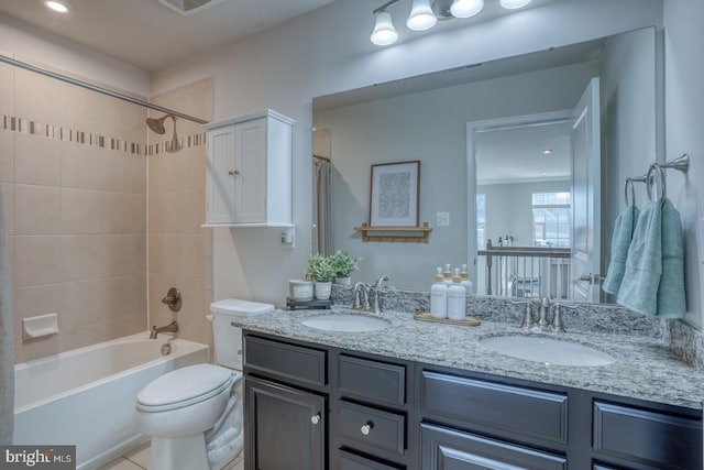 full bathroom featuring toilet, vanity, and tiled shower / bath