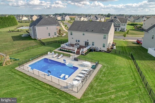 view of pool with a patio, a yard, and a wooden deck