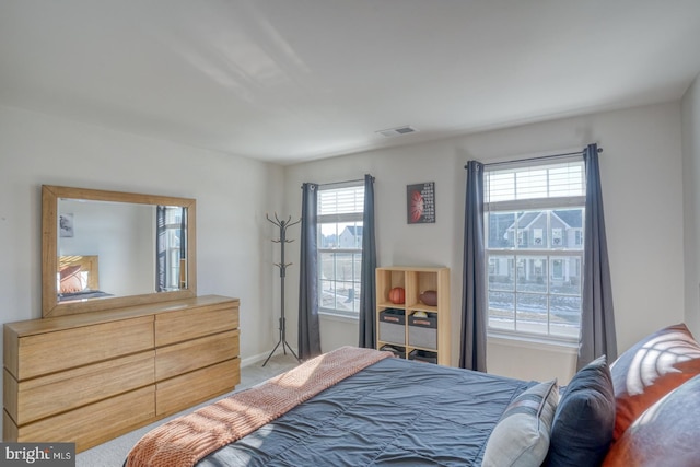 bedroom with light colored carpet