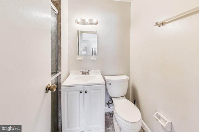 bathroom with toilet, a shower with door, and vanity