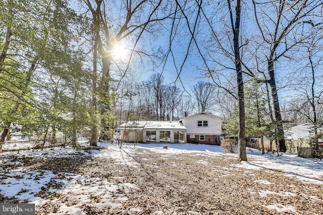 view of snow covered rear of property