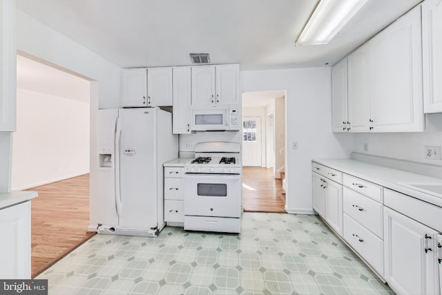 kitchen with white appliances and white cabinetry