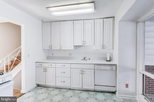 kitchen with sink, white appliances, and white cabinetry