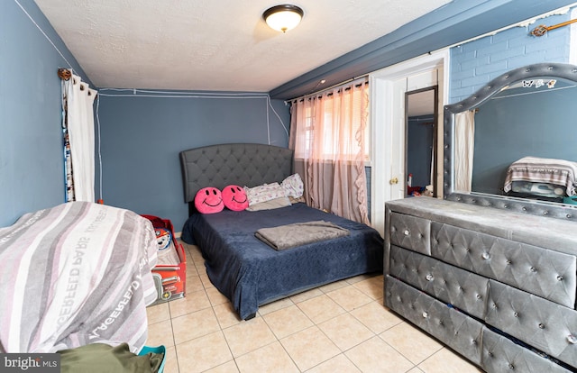 bedroom featuring a textured ceiling and light tile patterned floors