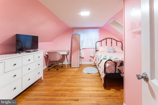 bedroom featuring vaulted ceiling and light hardwood / wood-style flooring