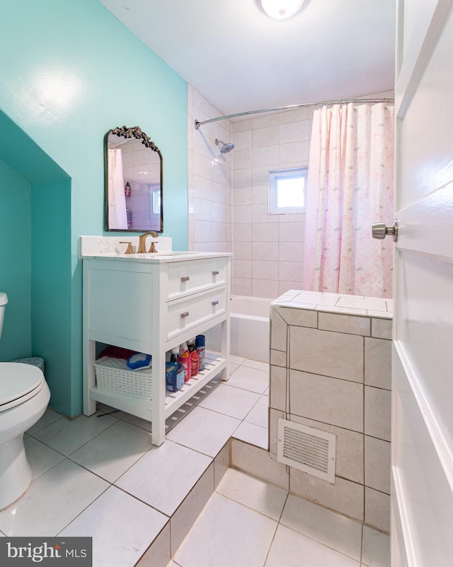 full bathroom featuring tile patterned floors, toilet, vanity, and shower / bath combination with curtain