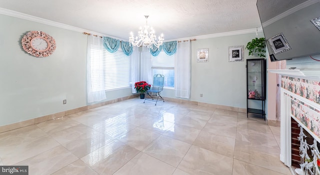 unfurnished dining area with a brick fireplace, a textured ceiling, crown molding, and an inviting chandelier