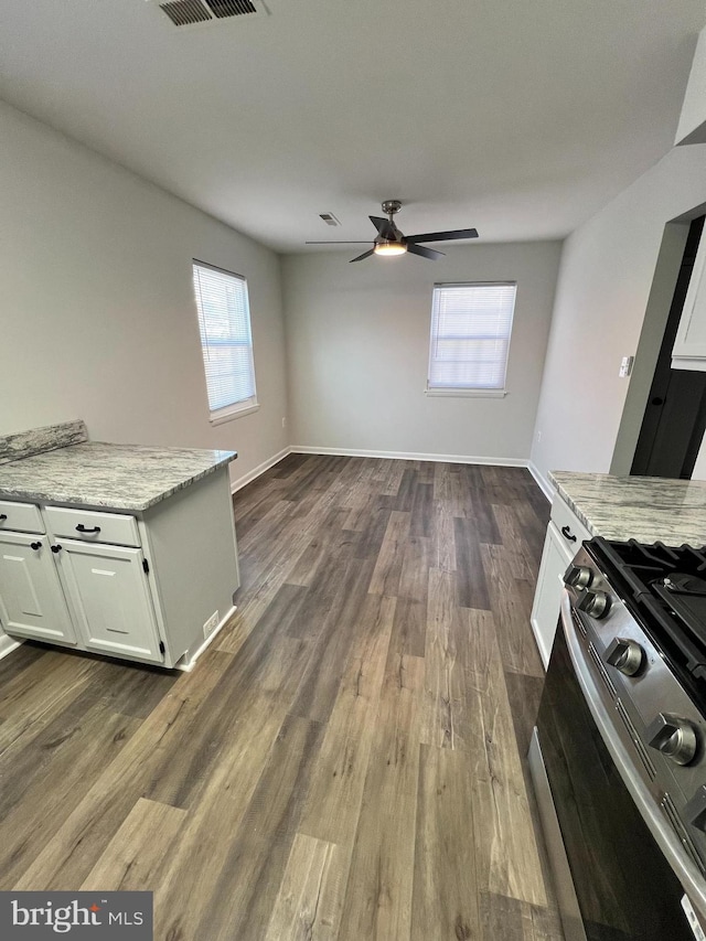 interior space with ceiling fan and dark hardwood / wood-style floors