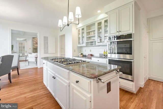 kitchen with white cabinets, a center island, and appliances with stainless steel finishes