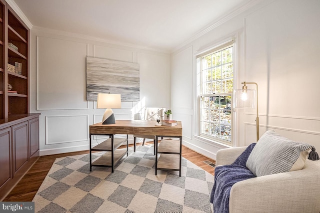 office area featuring wood-type flooring and ornamental molding