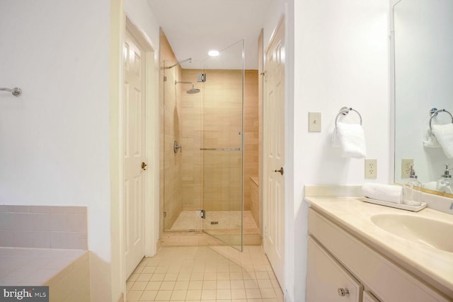 bathroom featuring vanity, tile patterned floors, and a shower with shower door