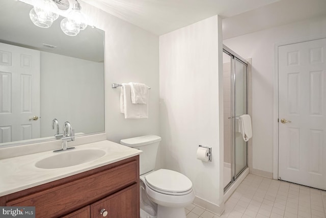 bathroom featuring vanity, tile patterned flooring, a shower with shower door, and toilet