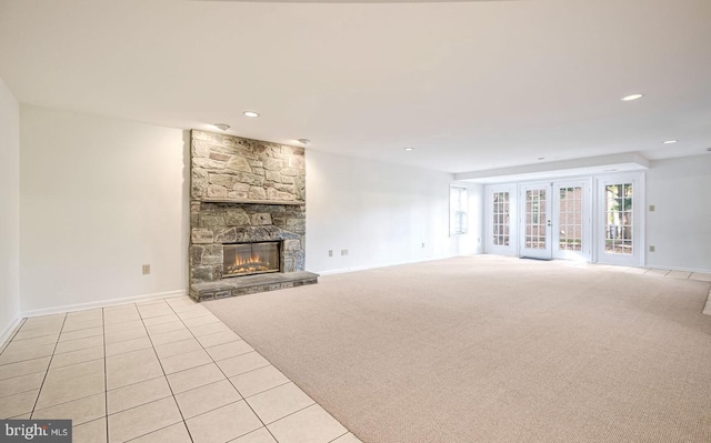 unfurnished living room featuring light carpet and a fireplace