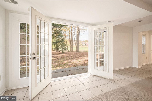 entryway with french doors and light tile patterned flooring