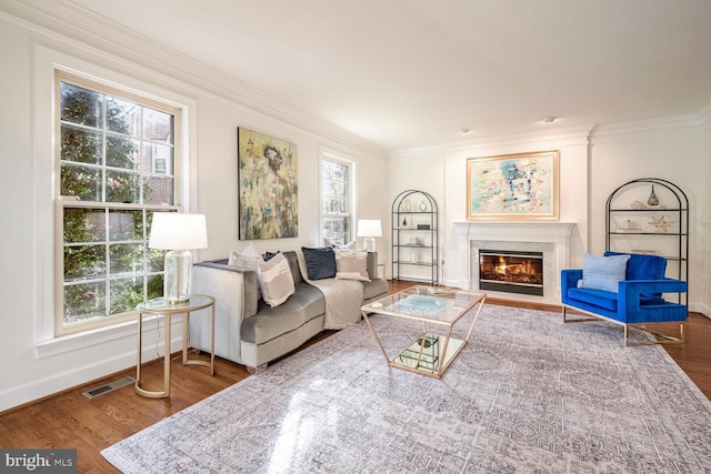 living room with wood-type flooring and ornamental molding