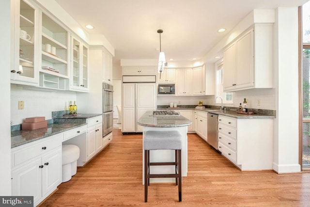 kitchen with built in appliances and white cabinetry