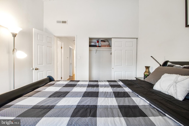 bedroom featuring a closet and a towering ceiling