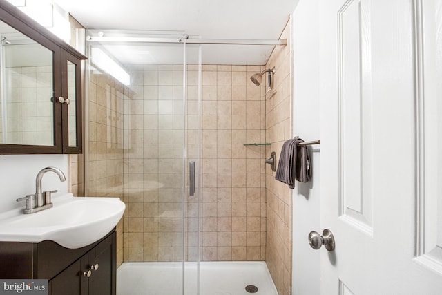 bathroom with an enclosed shower and vanity