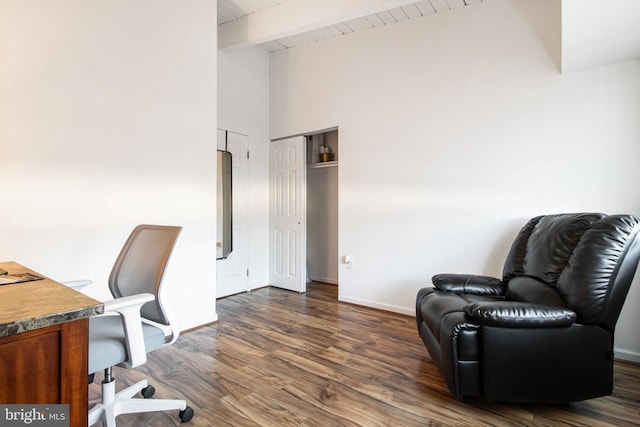 office space with beam ceiling, dark wood-type flooring, and wooden ceiling