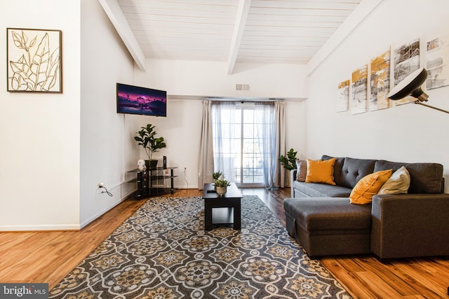 living room featuring beam ceiling, wood ceiling, and hardwood / wood-style flooring