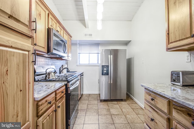 kitchen featuring appliances with stainless steel finishes, beamed ceiling, tasteful backsplash, light stone counters, and wooden ceiling