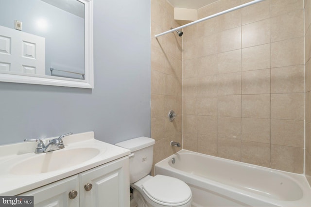 full bathroom featuring toilet, tiled shower / bath, and vanity