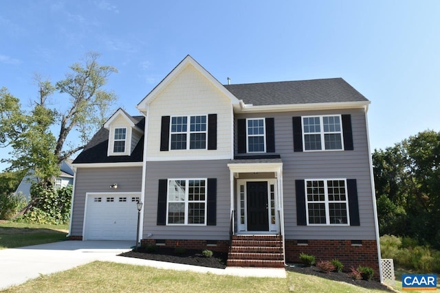 colonial-style house featuring a front yard and a garage