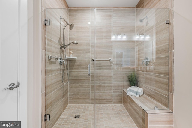 bathroom featuring a shower with shower door